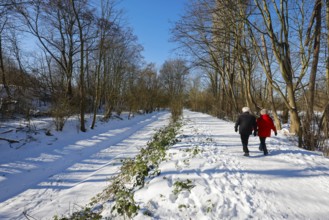 Bochum, North Rhine-Westphalia, Germany - Sunny winter landscape in the Ruhr area, walkers in ice