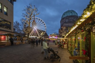 Ferris wheel at the winter village, Christmas market at dusk, St Elisabeth's Church on the right,