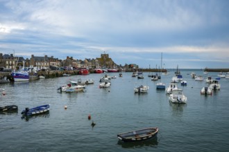 Barfleur, Normandy, France - Fishing boats on the quay in the harbour of Barfleur, a picturesque