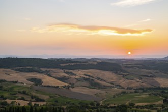 View from Montepulciano into a typical Tuscan landscape in Val d'Orcia with hills, trees, fields,