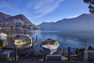 Motorboats, hill, village, haze, blue sky with cirrostratus clouds, Lake Lugano, Lugano, Lugano