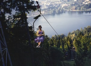 Young woman sitting in chairlift above the Lake Bled, Bled, Slovenia, former Yugoslavia, Europe