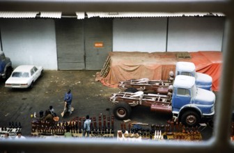 Trucks on the quay and traders with tourist souvenirs, harbour of Dakar, Senegal, West Africa,