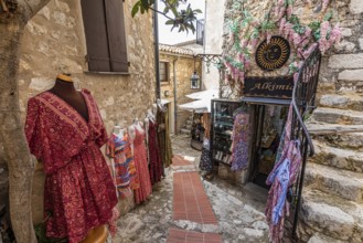 Women's clothing in front of Boutique Alkimia in the mountain village of Èze Village on the Côte