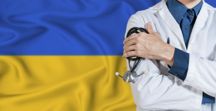 Doctor with stethoscope on Ukraine flag. Doctor holding stethoscope on Ukraine flag