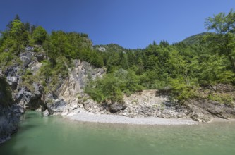 The Lammer creek is flowing fast through the Lammerklamm on a sunny hiking day. Blue sky, turquoise