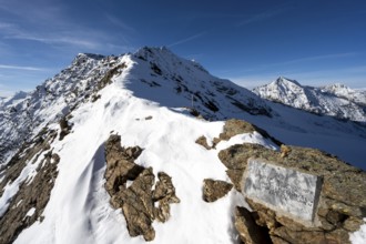 Memorial plaque on the Ramoljoch, mountain landscape in autumn with snow, Ötztal Alps, Tyrol,