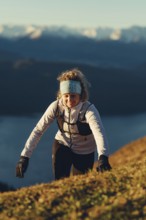 Trail running in autumn on the Jochberg on Lake Walchensee against the wonderful backdrop of the