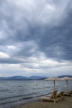 Kalamaki, Corfu, Greece, Sun loungers and parasols on Kalamaki beach in the north-east of the Greek