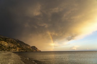 A thunderstorm with rainbow on the beach of Sougia in the south of Crete, Greece, Europe