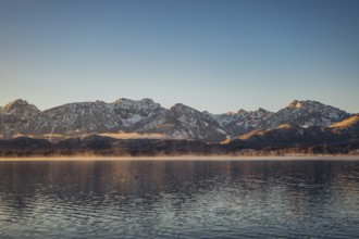 Frosty morning atmosphere during sunrise at Lake Hopfensee in the Allgäu in Bavaria, Germany,