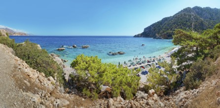 Overview of a beach scene at Apella beach with rocks and turquoise water, Apella beach, Karpathos,