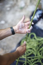 A climber pulls on a rope to climb on the rock, Morsbach, 09.07.2024