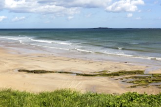 Wide sandy beach at Seahouses, Northumberland, England, UK