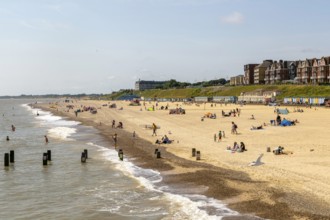 People enjoying sunny weather on sandy South Beach, Lowestoft, Suffolk, England, UK