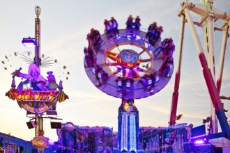 People on the illuminated carousel Mr Gravity in motion, Cranger Kirmes, Herne, Ruhr area, North