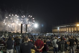 Spectators watch the fireworks at the Pyronale on the Maifeld at the Olympic Stadium, Berlin,