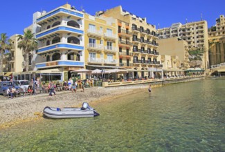 Waterfront hotel buildings beach and sea at Xlendi, island of Gozo, Malta, Europe