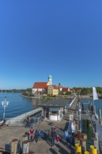 Moated castle, Lake Constance, kiosk, jetty, tourists, flag, parish church of St George, onion