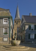 Historic upper town with horse fountain and church tower of St. Lambertus, Mettmann, Bergisches