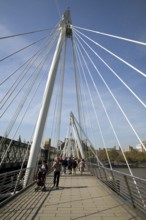 People crossing the Golden Jubilee bridge, London