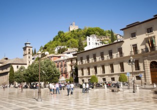 Historic buildings in Plaza Nueva, Granada, Spain looking up at part of the Alhambra on a hill top