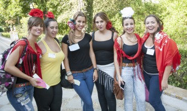 A group of pretty girl students studying tourism and hospitality welcoming tourists to the city,