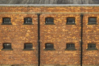 Cell windows with bars, exterior of Victorian jail museum, Lincoln Castle, city of Lincoln,