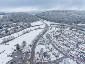 Winter picture of a settlement and surrounding woods under a blanket of snow, Aidlingen, Böblingen