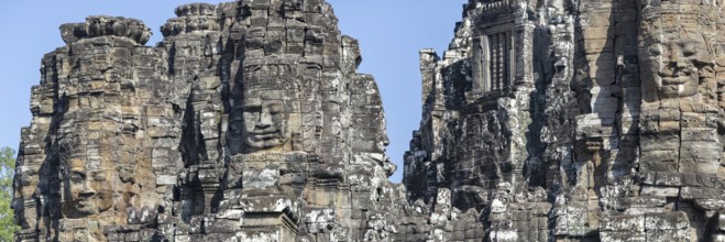 Panoramic image of giant stone-carved faces of the Bodhisattva Lokeshvara, also known as