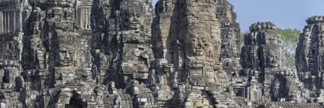 Panoramic image of giant stone-carved faces of the Bodhisattva Lokeshvara, also known as