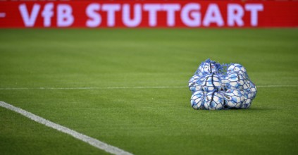 Adidas Derbystar match balls in ball net lying on grass, behind them perimeter advertising VfB