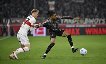 Tackle, action foul holding Chris Führich VfB Stuttgart (27) v Michael Olise FC Bayern Munich FCB