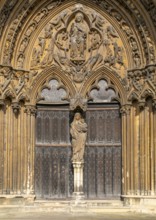 Statue of Mary and baby Jesus in doorway, The Judgement Porch, Lincoln Cathedral, Lincoln,