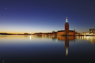 Illuminated silhouette of the town hall at night with reflections in the water, Stadshus, Nobel