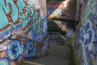 Stairs under the city railway bridge to the canal, graffiti, waterway, Linden harbour lock, Limmer,