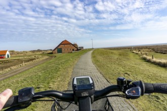 The East Frisian North Sea island of Juist in winter, cycling in the west of the island, on dyke