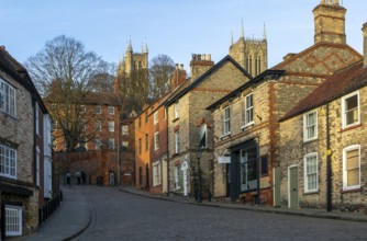 Cathedral towers rising above buildings, Steep Hill in evening light, Lincoln, Lincolnshire,