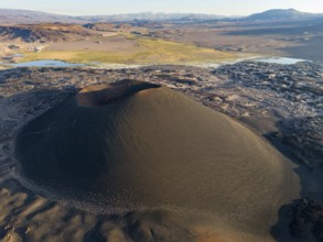 Aerial view of a large volcanic crater in the middle of a barren desert landscape, Argentina,