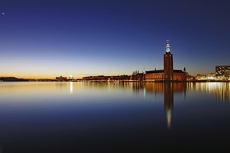 City view at dusk with tower of the town hall and water reflections, Stadshus, Nobel Prize,