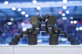 Stack of ice hockey pucks artfully arranged on the sidelines, Heilbronner Falken Vs Bietigheimer