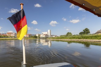 German flag on the ferry, in the background the city view with Elbe, Riesa, Saxony, Germany, Europe