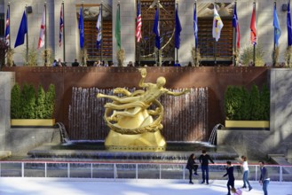 Sculpture of Prometheus in the middle of a fountain in front of an ice rink, decorated with