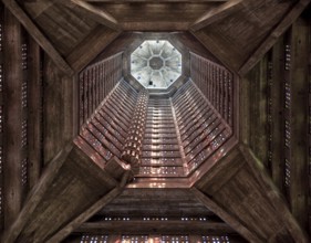 Interior view of the tower looking upwards, spiral staircase on the left coloured glass window by