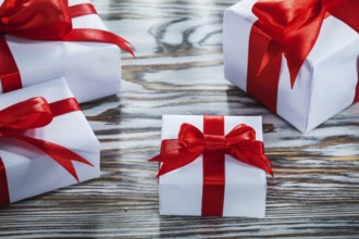 Assortment of red gift boxes on wooden surface