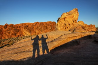 Shadows of hikers on the Fire Canyon Overlook, Valley of Fire State Park, Nevada, USA, North