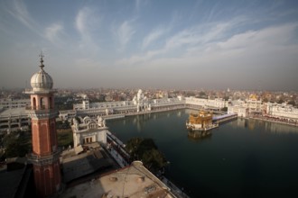 Aerial view of city and Harmandir Sahib or Darbar Sahib or Golden temple and Tower of Ramgarhia