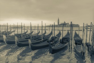 Cloudy atmosphere at sunrise, gondolas, San Giorgio Maggiore church in the background, Venice,