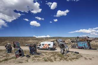 Motorhome and scrap cars decorated with graffiti in the Carforest of Goldfield, Nevada, USA, North