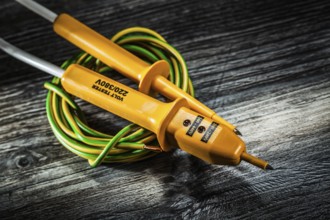 Electric cable tester on wooden board